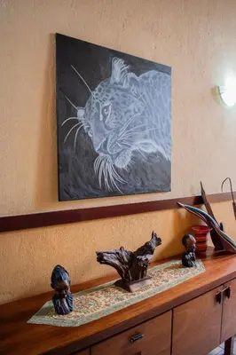 a painting of a tiger on top of a cabinet at Namagong in Marloth Park