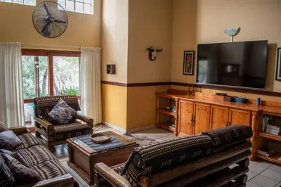 a living room with a couch and a flat screen tv at Namagong in Marloth Park