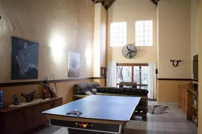 a living room with a ping pong table in it at Namagong in Marloth Park