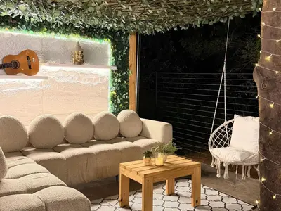 a patio with a couch and a guitar and a table at 156 Euphoria Boutique Villa - Euphoria Golf Estate Hydro in Naboomspruit
