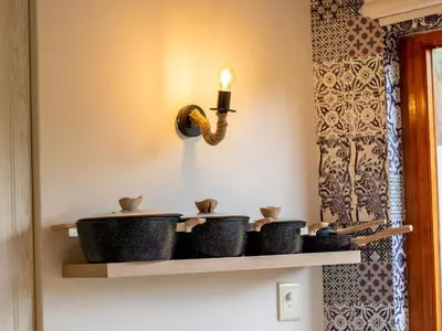 a shelf with pots and pans on a wall at 156 Euphoria Boutique Villa - Euphoria Golf Estate Hydro in Naboomspruit