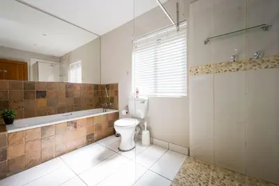 a bathroom with a toilet and a bath tub at Raptors Wildlife Escapes in Hoedspruit