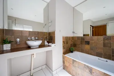 a bathroom with a sink and a bath tub at Raptors Wildlife Escapes in Hoedspruit