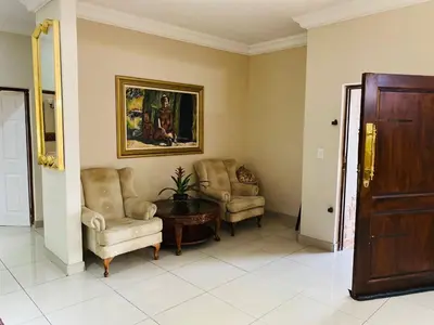 a living room with two chairs and a table at The Adress in Midrand