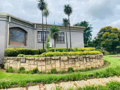 a house with palm trees in front of it at The Adress in Midrand