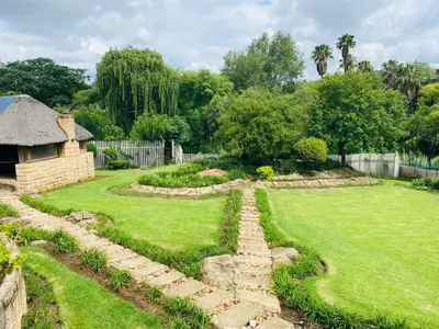 a garden with a stone path in a yard at The Adress in Midrand