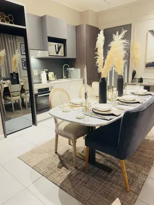 a kitchen and dining room with a table and chairs at French love, Menlyn Maine in Pretoria