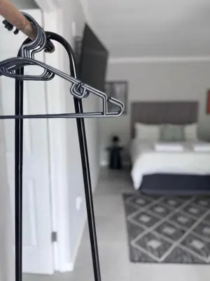a room with a bed and a black at Nelspruit Modern Apartment #2 - Self Check-In in Nelspruit