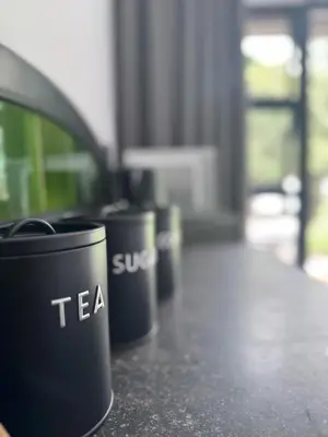 a row of black cups sitting on a counter at Nelspruit Modern Apartment #2 - Self Check-In in Nelspruit
