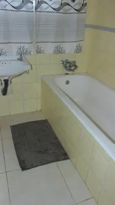 a bathroom with a bath tub and a sink at Phana Quest house in Evander