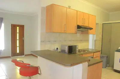 a kitchen with a counter top and a microwave at Phana Quest house in Evander