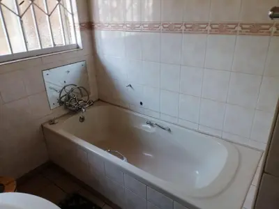 a white tub in a bathroom with a window at 4 Seasons Country Club in Vosburg