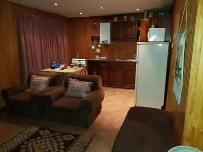 a kitchen with two couches and a refrigerator at 4 Seasons Country Club in Vosburg