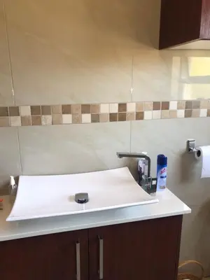 a bathroom sink with a faucet on a counter at Nyumbani in Kempton Park