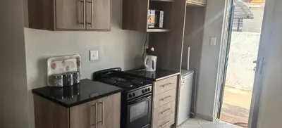 a small kitchen with a stove and a sink at Lerato's Guesthouse 840 in Polokwane