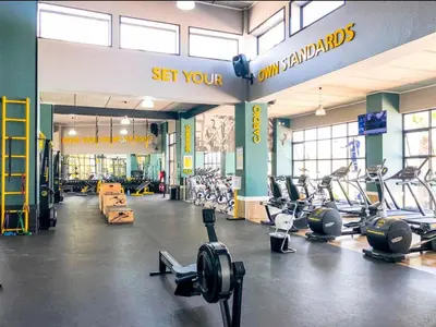 a gym with lots of treadmills and exercise bikes at Apartment at The Blyde in Pretoria