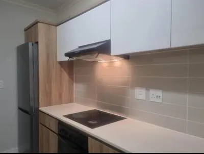 a kitchen with a stove and a refrigerator at Apartment at The Blyde in Pretoria