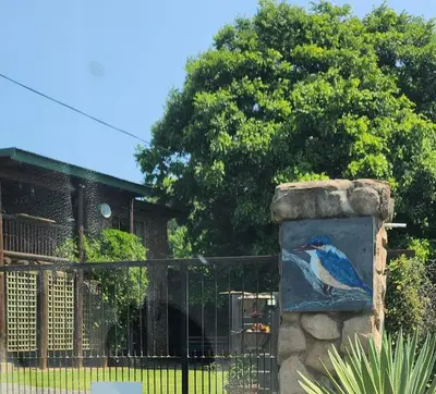 a painting of a blue bird on a stone wall at KINGFISHER BLUE on Milkwood in Sabie
