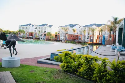 a statue of a dog in front of a pool at The blyde crystal lagoon 116 in Pretoria