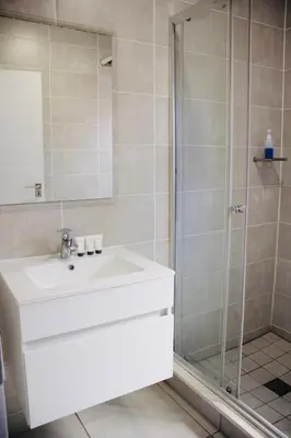 a bathroom with a sink and a shower at The blyde crystal lagoon 116 in Pretoria