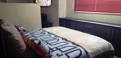 a bedroom with a bed and a window with a window blindiosyn at Berchtesgaden Lifestyle Farm - Farmstay in Vaalwater