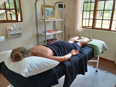 a naked woman laying on a bed in a room at Berchtesgaden Lifestyle Farm - Farmstay in Vaalwater