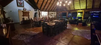a living room with a table and a zebra on the floor at Berchtesgaden Lifestyle Farm - Farmstay in Vaalwater