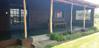 a porch of a cabin with a picnic table in it at Berchtesgaden Lifestyle Farm - Farmstay in Vaalwater