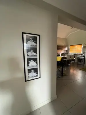 a picture hanging on a wall in a living room at Nane's Tranquil Retreat in Midrand