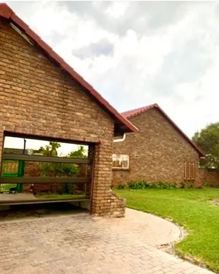 a brick house with a large garage at Chatsvilla in Boksburg