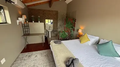 a bedroom with a bed and a sink in it at Marloth Park, Self Catering Buffel st 4347 in Marloth Park