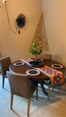 a dining room table with a plant on top of it at Marloth Park, Self Catering Buffel st 4347 in Marloth Park
