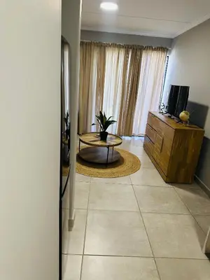 a living room with a coffee table and a television at Homely Stay 3 in Kempton Park