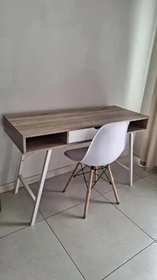 a wooden desk with a white chair next to it at Luxury Apartments in Midrand