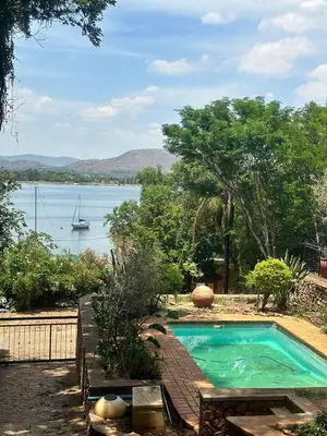 a swimming pool with a boat in the water at 100 on Simon Bekker Kosmos in Hartbeespoort