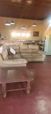 a living room with a couch and a coffee table at Stone Haven Lodge in Kliprivier