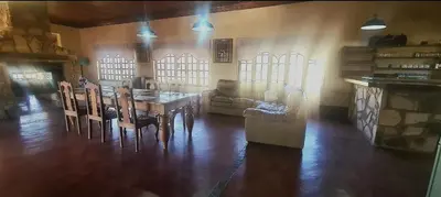 a living room with a table and chairs and a couch at Stone Haven Lodge in Kliprivier