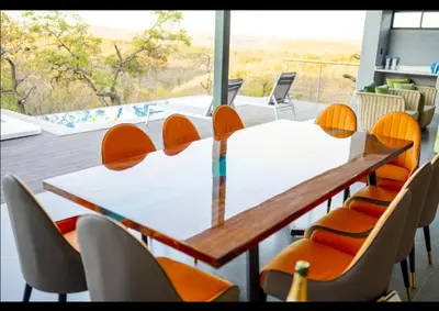 a conference room with a white table and chairs at La-Ngwenya Serenite in Warmbaths