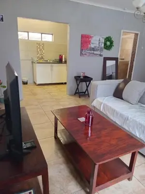 a living room with a couch and a coffee table at Lu&Me in Polokwane
