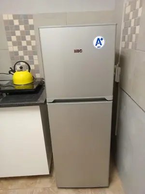 a refrigerator in a kitchen with a yellow tea kettle at Lu&Me in Polokwane