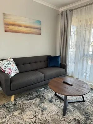 a living room with a couch and a coffee table at The Blue Oasis in Midrand