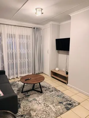 a living room with a couch and a coffee table at The Blue Oasis in Midrand
