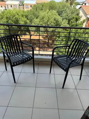 two benches sitting on top of a balcony at Suburban bliss in Midrand