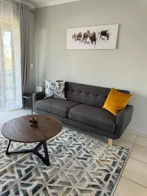 a living room with a couch and a coffee table at Suburban bliss in Midrand