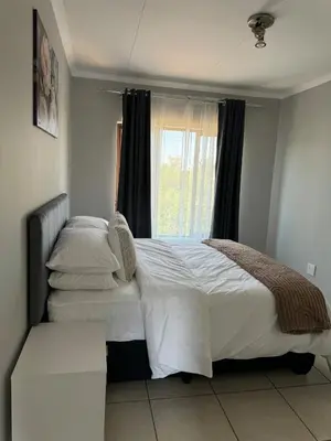 a bedroom with two beds and a window at Suburban bliss in Midrand