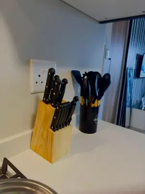 a knife block filled with knives on top of a counter at Dimension in Midrand