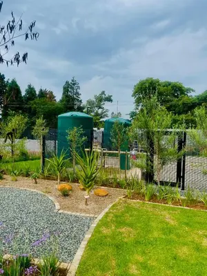 a garden with a fence and some plants at Dimension in Midrand