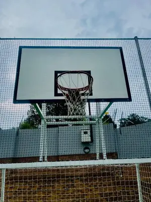 a basketball hoop on a net on a fence at Dimension in Midrand