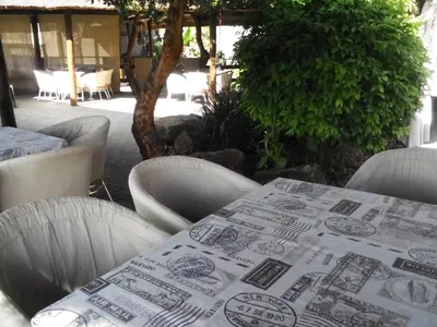 a table with chairs and a table cloth on it at Gabbata Lodge in Leeuwfontein