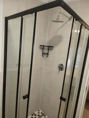 a shower with a glass door in a bathroom at Limewood 2 in Sandton
